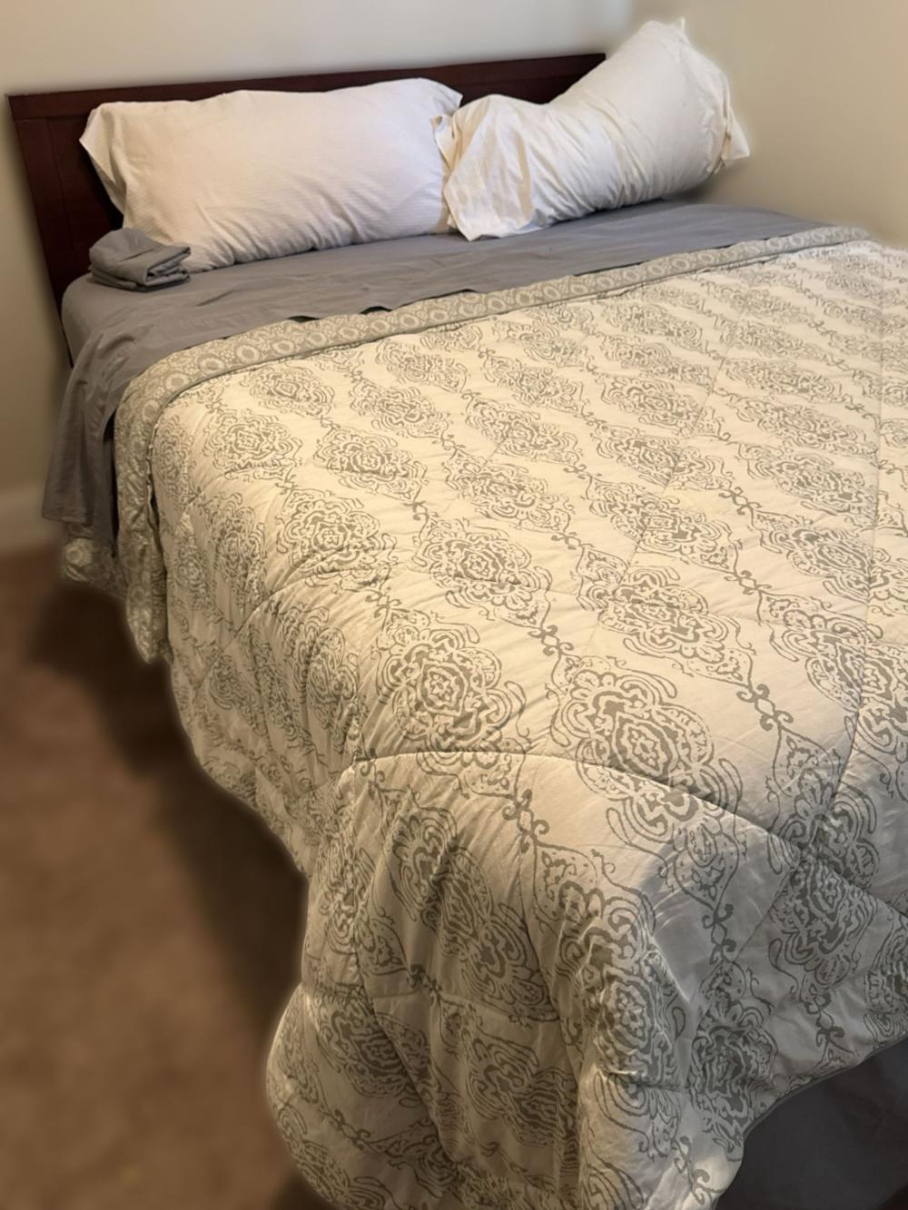 Full Wooden Bed Frame With Storage And Patterned Comforter