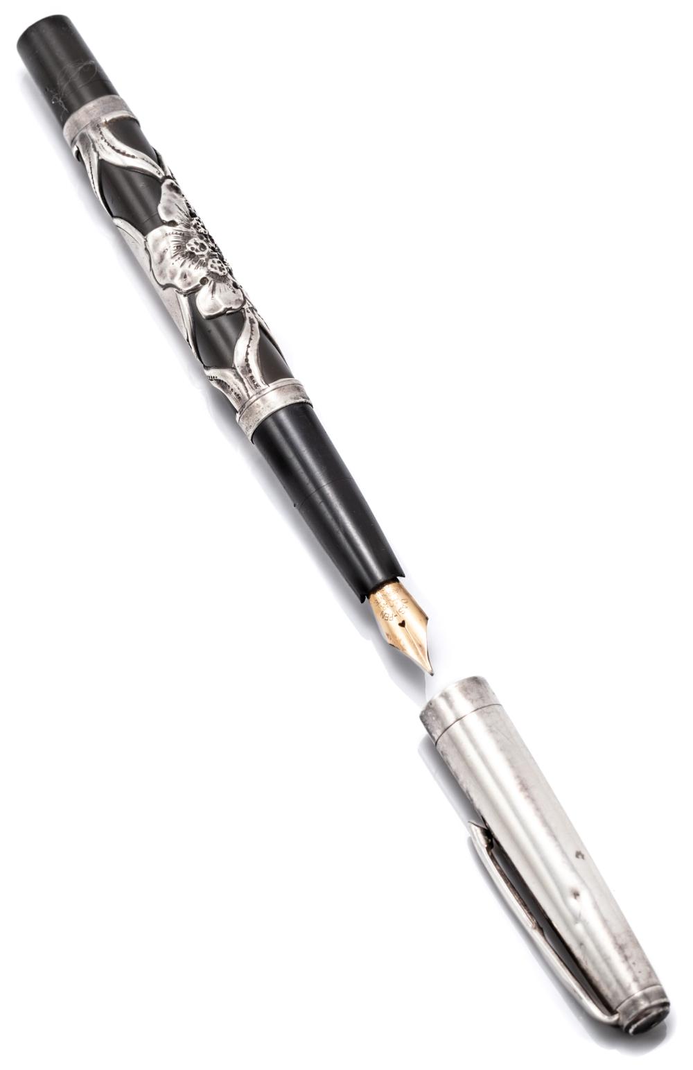 AN ART NOUVEAU SILVER OVERLAY PEN; brown bakelite pen with applied silver work featuring a flower and uninscribed cartouche, stamped...