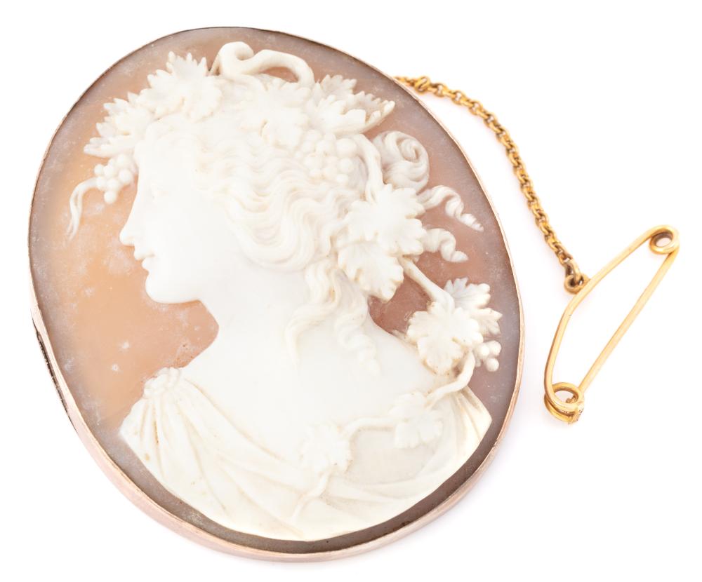 AN ANTIQUE 9CT ROSE GOLD FRAMED CAMEO BROOCH; oval finely carved shell cameo depicting portrait of Bacchante in a plain frame with 1...