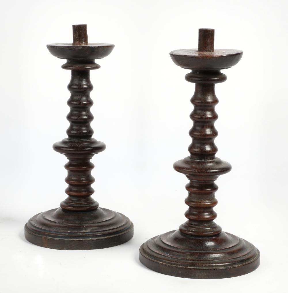 A pair of Continental Baroque turned oak candlesticks, 18th century
