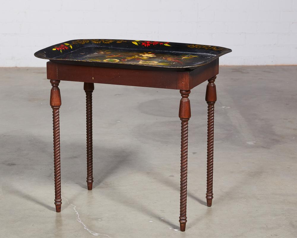A large tole peinte tray on associated stained wood stand