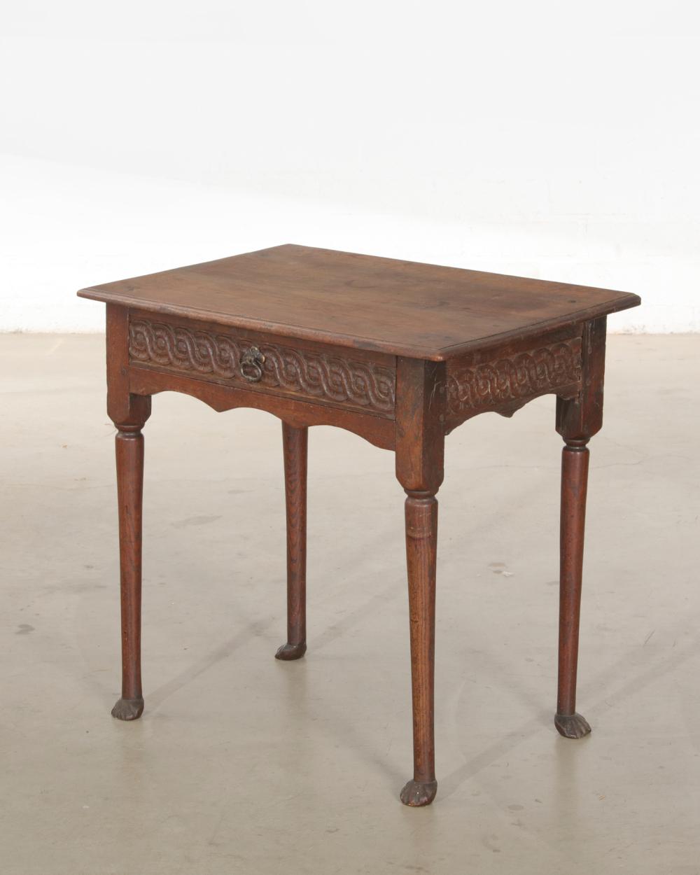 A George II carved oak side table, composed of antique elements