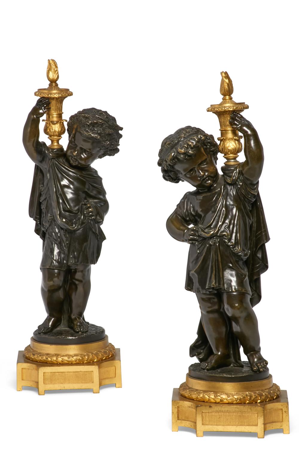 A pair of Louis XVI style parcel gilt and patinated bronze models of putti, late 19th century