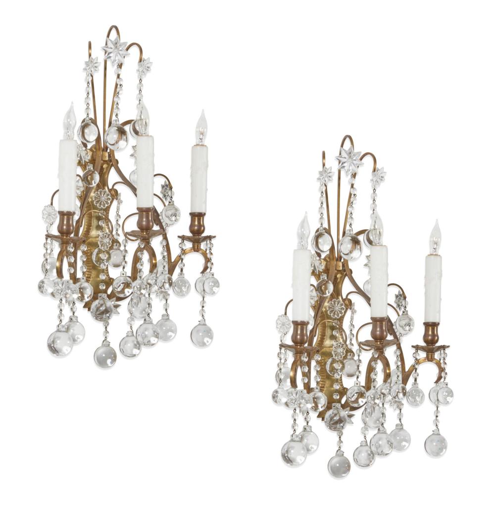 A pair of Continental Baroque style bronze, cut and pressed clear glass three branch wall lights, 20th century