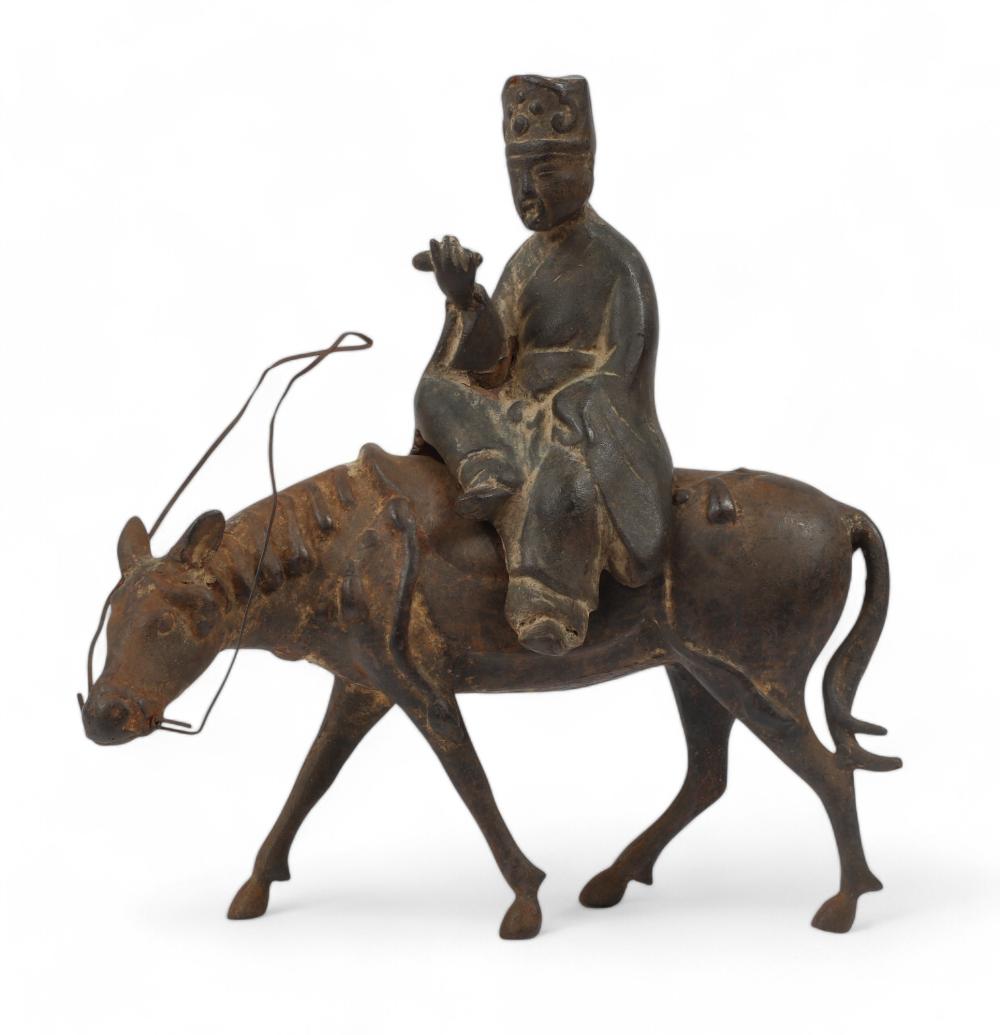 An Asian metalware model of a horse and rider