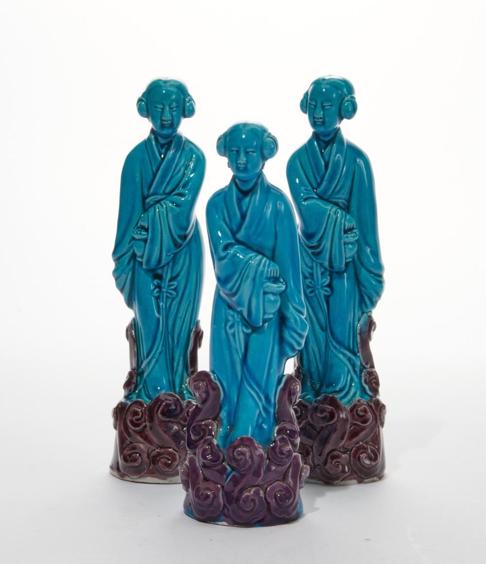 A group of three Chinese blue glazed pottery figures of standing beauties