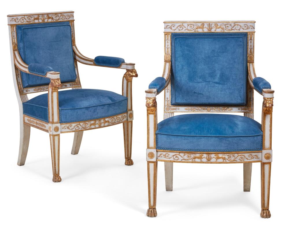 A pair of Empire parcel gilt and white painted fauteuils, early 19th century
