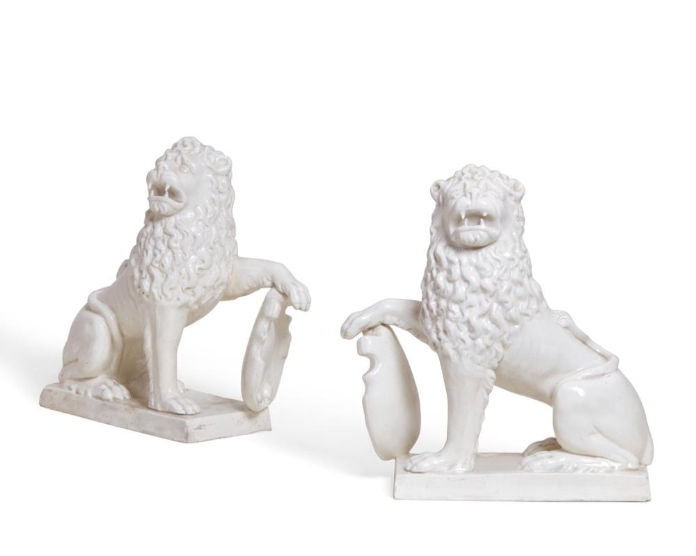 A pair of Continental white glazed earthenware models of heraldic lions, circa 1900