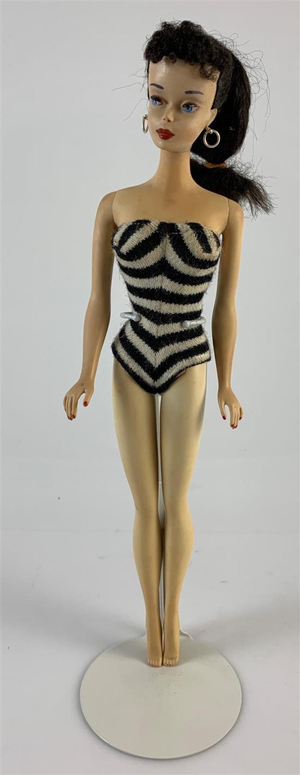 #3 BRUNETTE BARBIE. BLUE IRISES WITH BROWN EYELINER, PONYTAIL WITH SOFT CURLY BANGS, PARTIALLY SOLID TORSO.