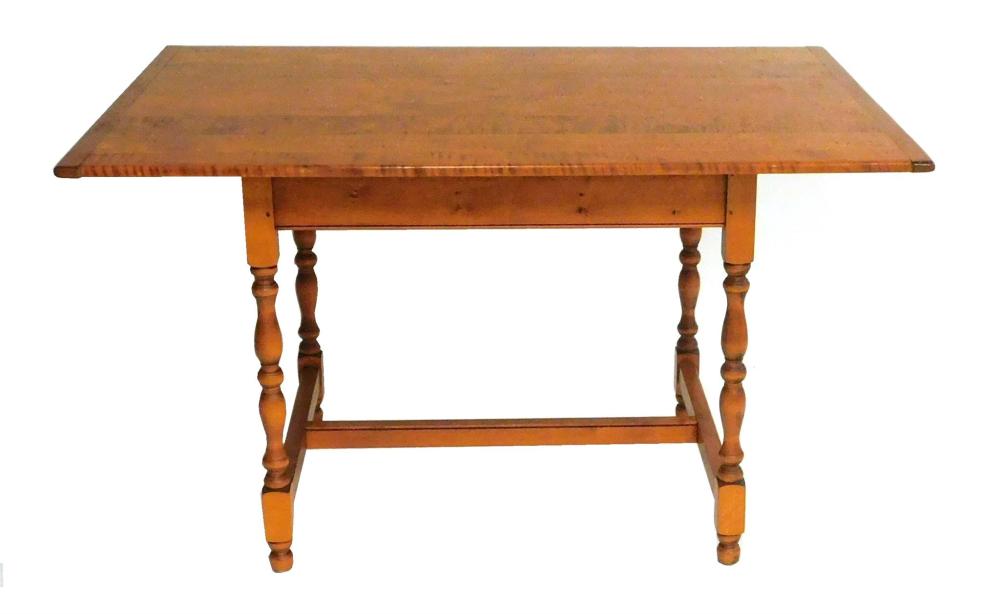 Warren Chair Works tiger maple tavern table, seven board top with breadboard ends on turned trestle base, hand-carved maker's mark t..