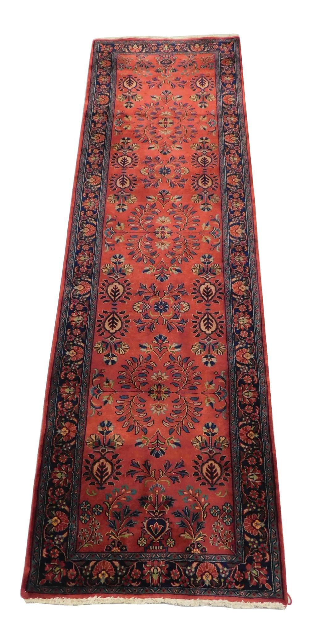 RUG: Modern Indo-Persian sarouk design runner, 2' 9" x 9' 9", wool on cotton, red field with tan, navy and light blue accents, wear..