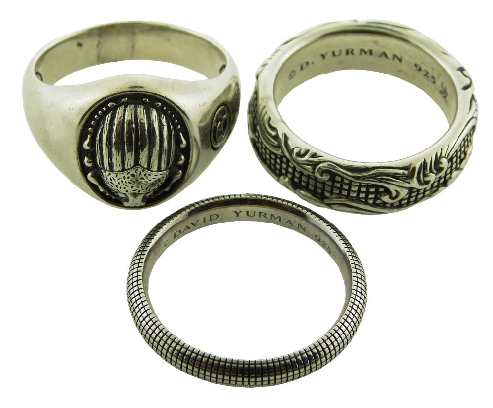 JEWELRY: Three Sterling Silver David Yurman rings including: waves design band, stamped: "925" sterling silver, width: 7mm, size: 10...