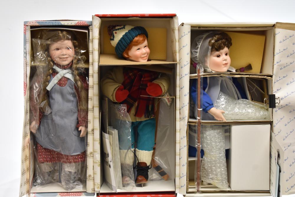 Three Collectible Dolls with Showcases