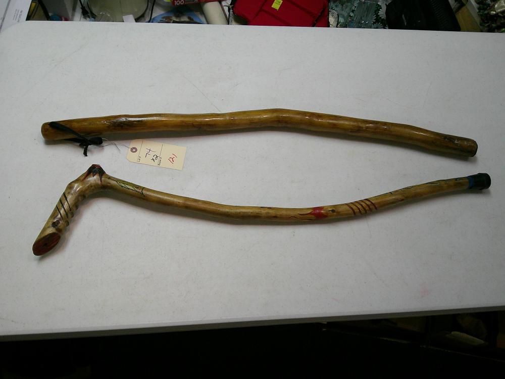 2 walking sticks - one is carved
