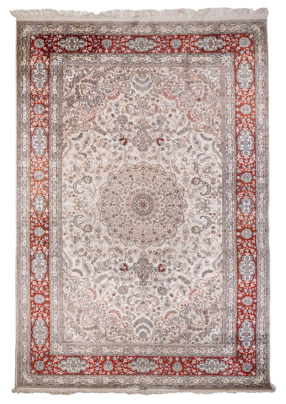 A Persian Ghoum silk medallion rug on an ivory ground, signed, 185 x 274 cm