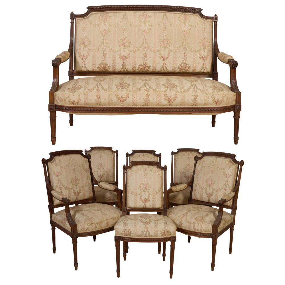 Seven Piece French Louis XVI Style Walnut Parlor Group, 20th c., Settee- H.- 40 in., W.- 52 in., D.- 23 in.; Armchair- H.- 38 in., W.- 24 in., D.- 20 in.; Side chair- H.- 35 1/2 in., W.- 19 1/2 in., D.- 16 in. (7 Pcs.)