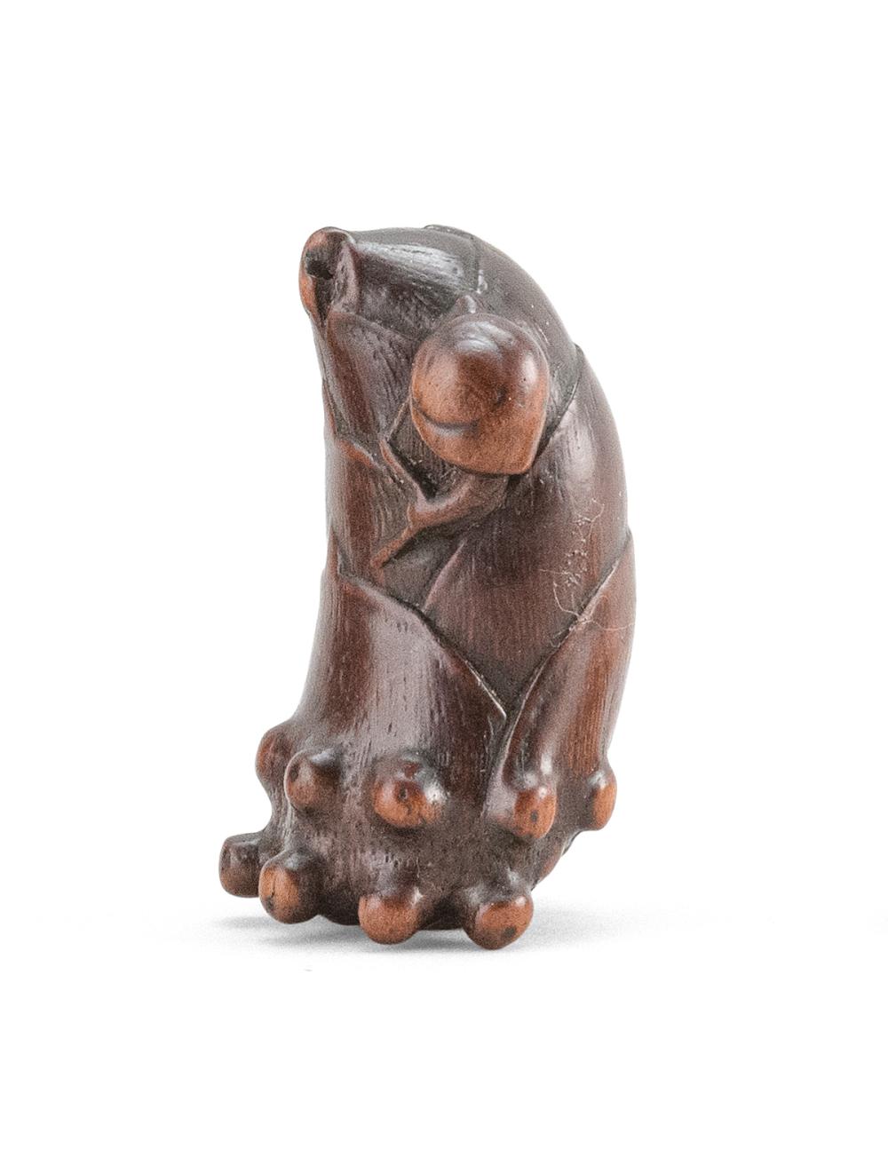 WOOD NETSUKE In the form of a snail resting on a bamboo shoot with extended feelers. Length 2.25". Ex Collection: Raymond Bushell.