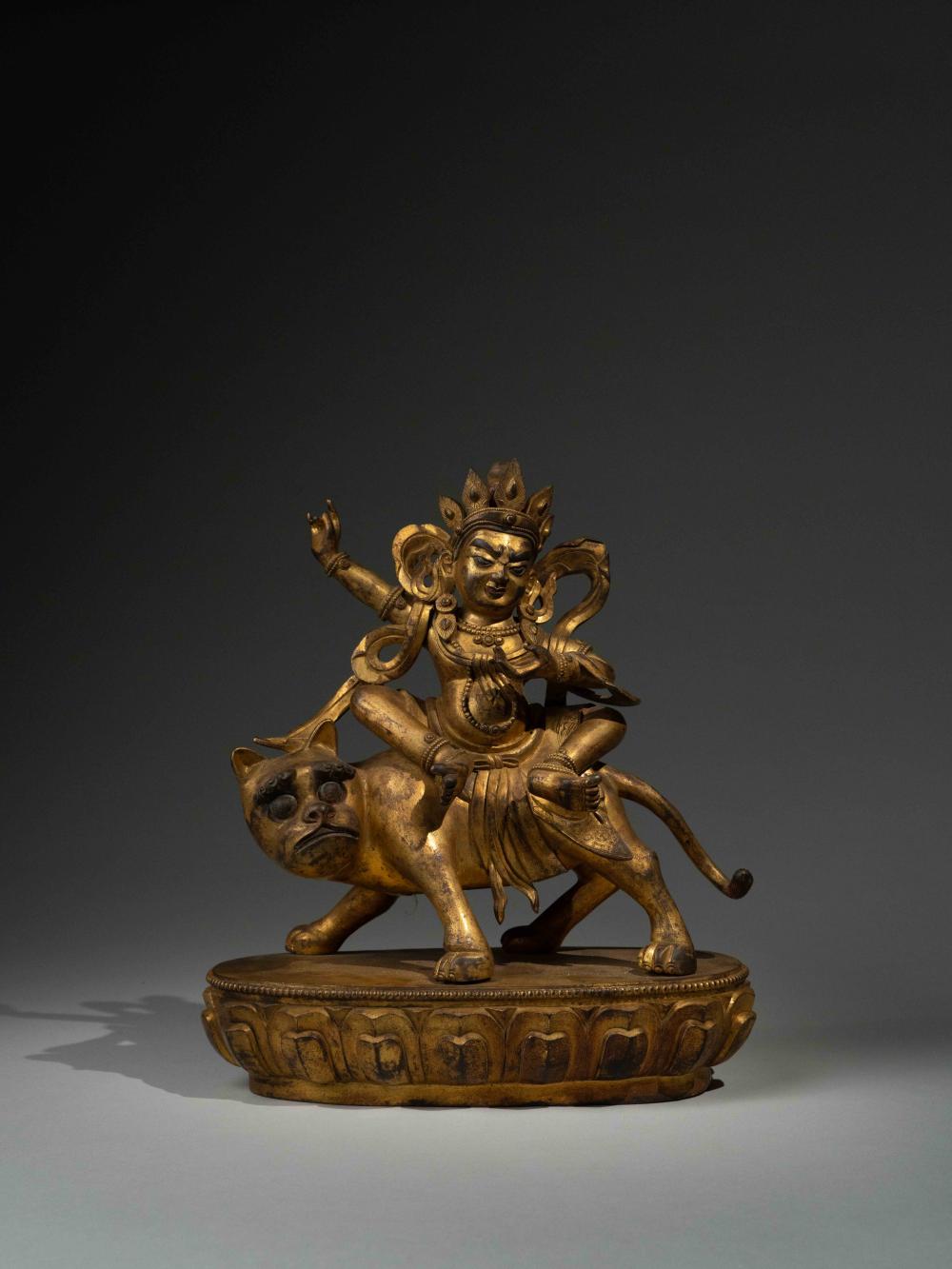A GILT-BRONZE FIGURE OF GUARDIAN 晚清或民國.銅鎏金騎獸護法