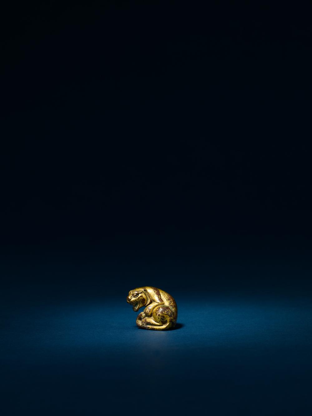 A GILT BRONZE FIGURE OF TIGER,HAN (202 B.C.-220 A.D.) 漢.銅鎏金臥虎