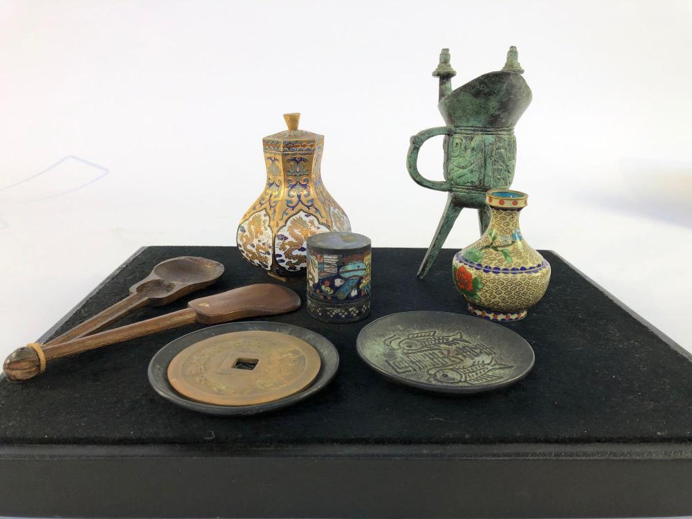A green patinated archaic style Chinese bronze 'Jue' wine tripod vessel