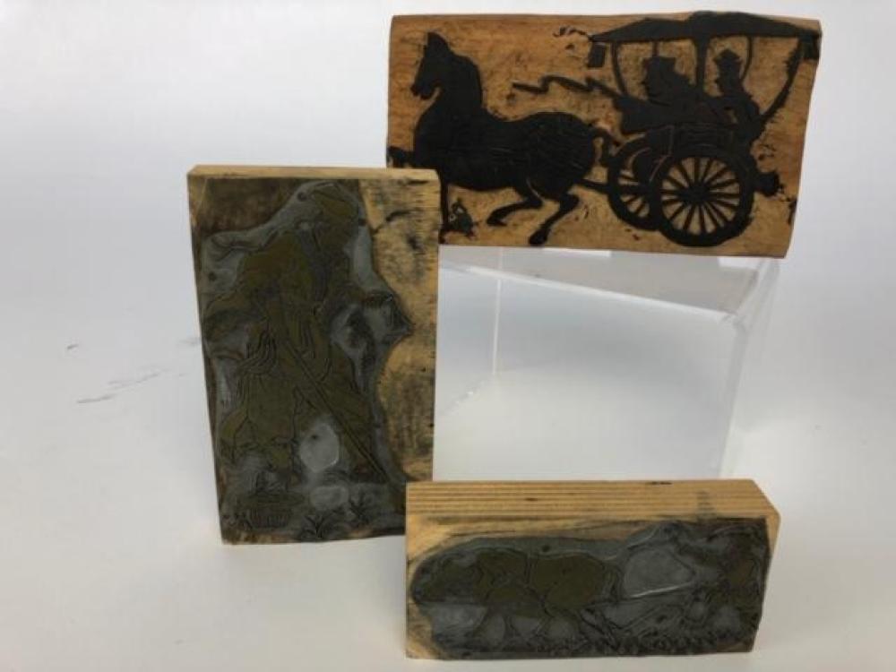 Two carved woodblocks with metal stencils together with a woodcut for textile printing carved with a horse and carriage