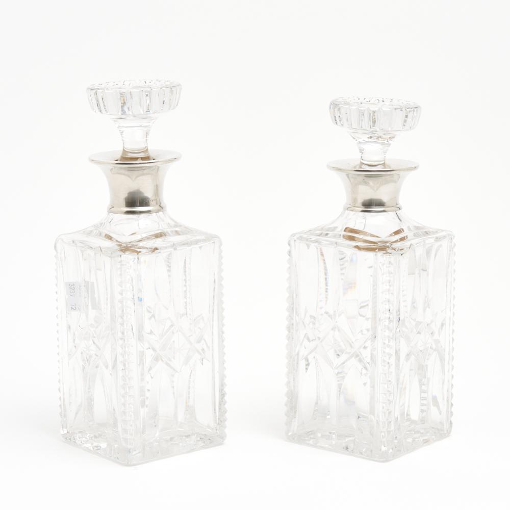 A NEAR PAIR OF FINELY CUT CRYSTAL AND STERLING SILVER MOUNTED DECANTERS H.25CM