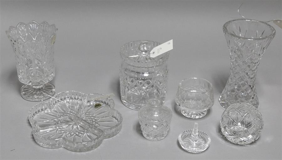 Assortment of eight clear glass items, some stamped Waterford crystal, including a lidded biscuit jar, two vases, a ring holder, and...