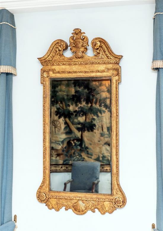 A George I giltwood rectangular upright mirror the associated plate bevelled to the top and sides and slightly to the bottom,