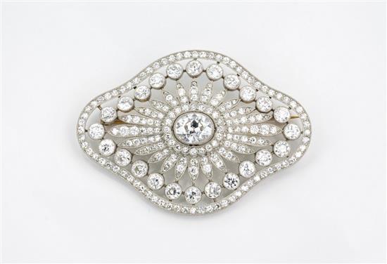 A fine platinum and diamond pendant brooch 1920s, designed as a flower within a lobed, quatrefoil openwork border,