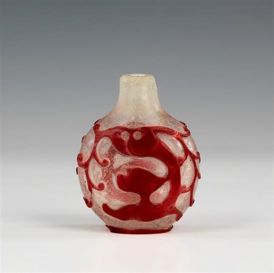 A Chinese red overlay on snowflake glass snuff bottle 18th / 19th century, of flattened moon form,