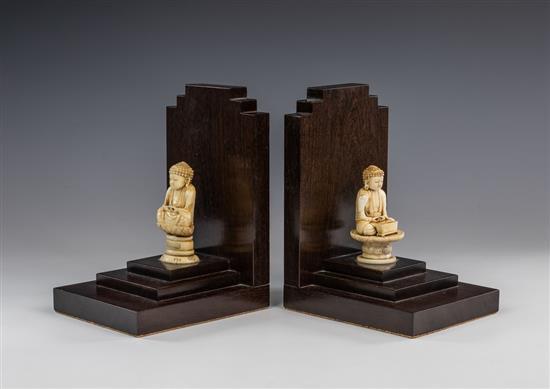 Two Chinese carved ivory figures of Buddha early 20th century, one seated upon a circular table, the other on an oval cushioned base,