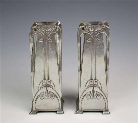 A pair of W.M.F polished pewter vases of tapering rectangular form with stylised Art Nouveau long stem floral decoration,
