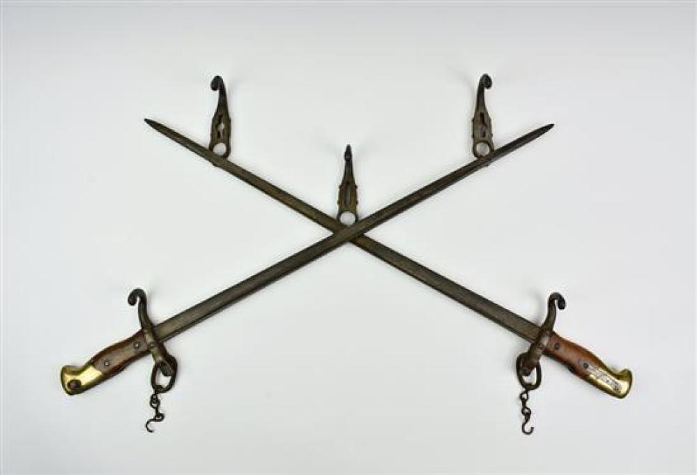 A trench art cross bayonet wall hanging hat rack 26in. (66cm.) wide.