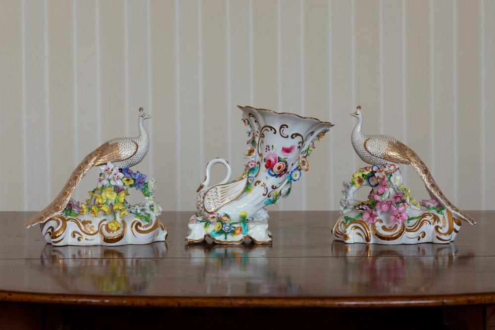 A pair of Derby porcelain peacocks second quarter 19th century, with elaborate gilt plumage,