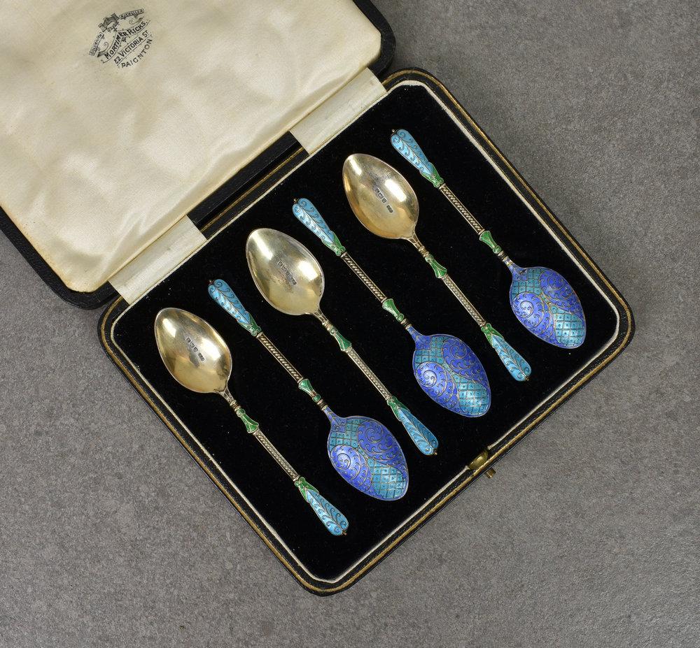 A cased set of six silver and enamel demitasse spoons Turner & Simpson Ltd., Birmingham 1932, with fancy terminals and bowls,