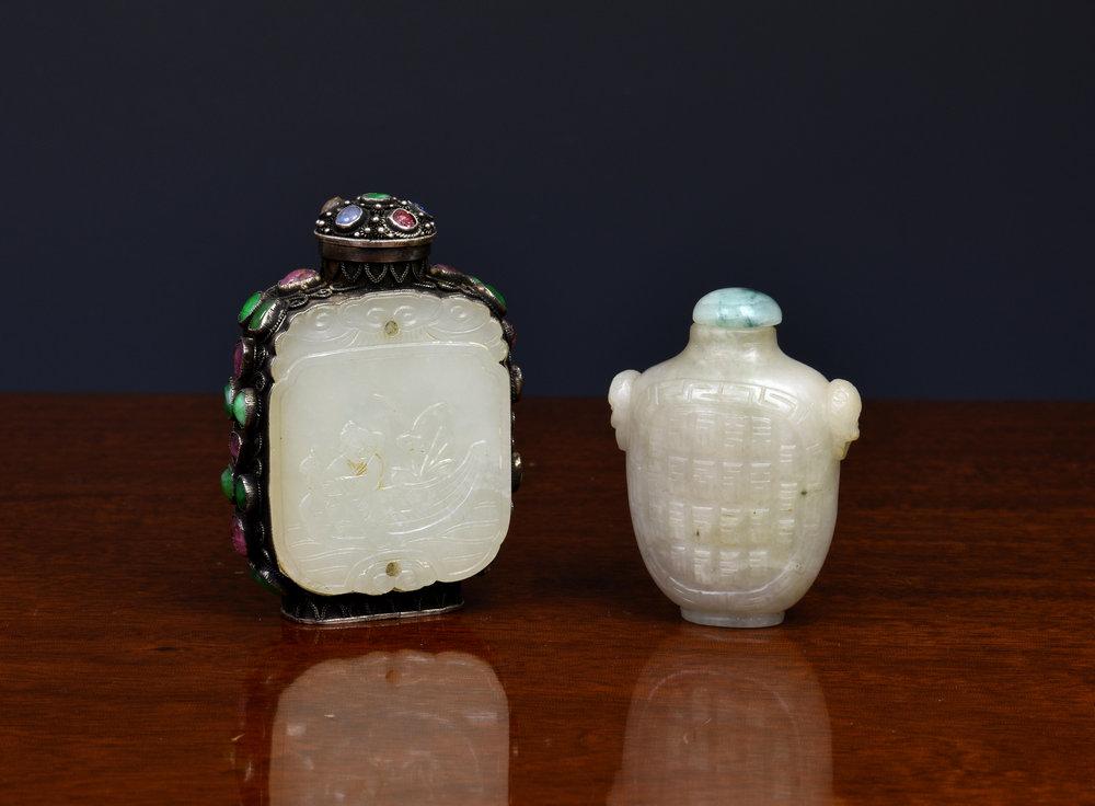 A Chinese pale jade snuff bottle of flattened vase form with carved twin mask ring handles,