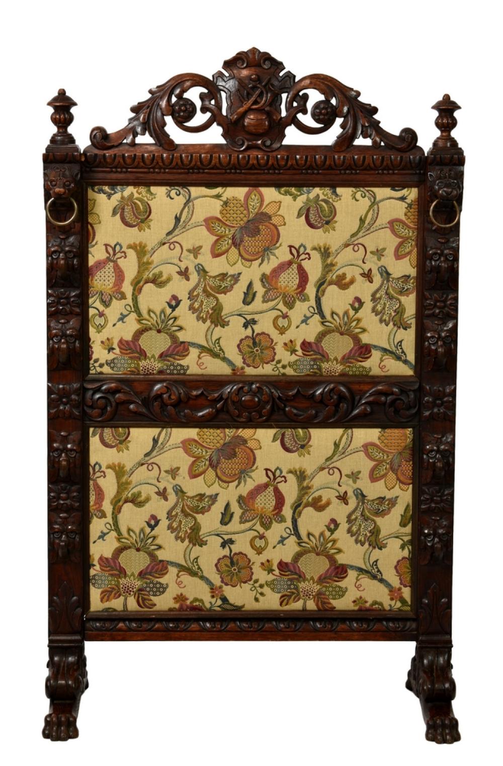 A Victorian carved oak Carolean revival fire screen the two panel frame carved with foliage,