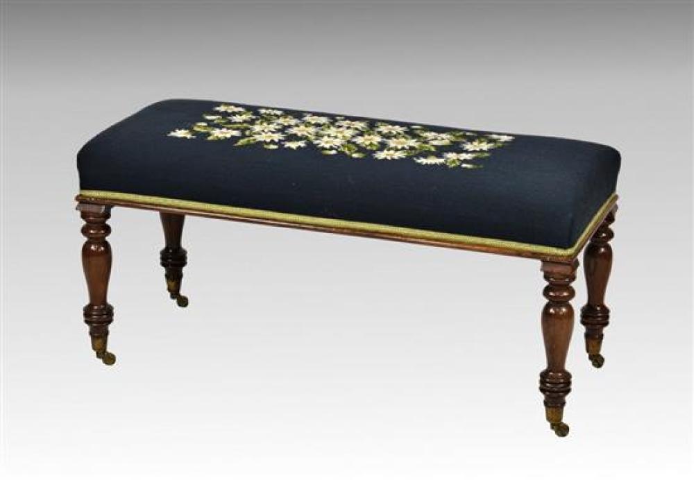 An early 19th century rosewood duet or long stool the floral petit point stuff over seat raised on baluster turned legs with brass c...
