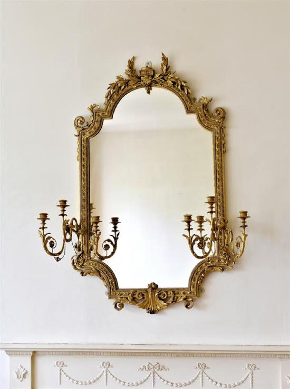 A good 19th century gilt and composition girandole mirror the angular cartouche shaped plate within a beaded and foliate running pat...