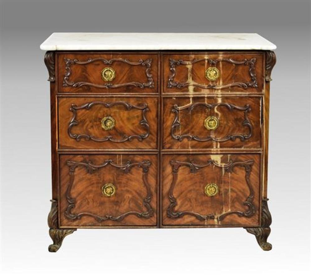 A 19th century Continental mahogany and marble commode the white marble top with eared front corners,