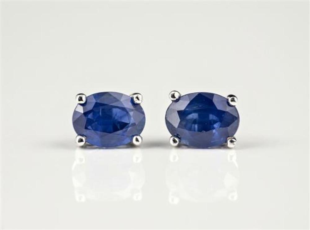 A pair of 18ct white gold and sapphire stud earrings the oval cut sapphires totalling 1.86cts. in four claw settings. (2)