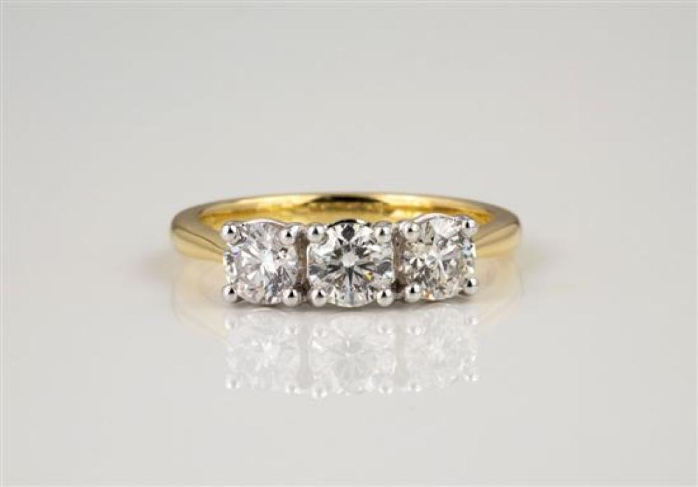 An 18ct yellow gold and diamond three stone ring the three brilliant cut diamonds totalling 1.21cts., ring size M.