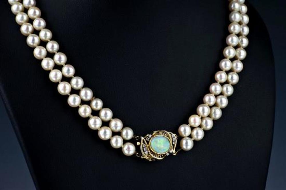 A two strand cultured pearl necklace with 14ct gold, opal and diamond clasp with 7mm. pearls,