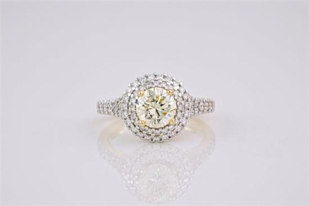 A light yellow diamond and 18ct gold ring The brilliant cut, light yellow diamond weighing approximately 1.23ct,