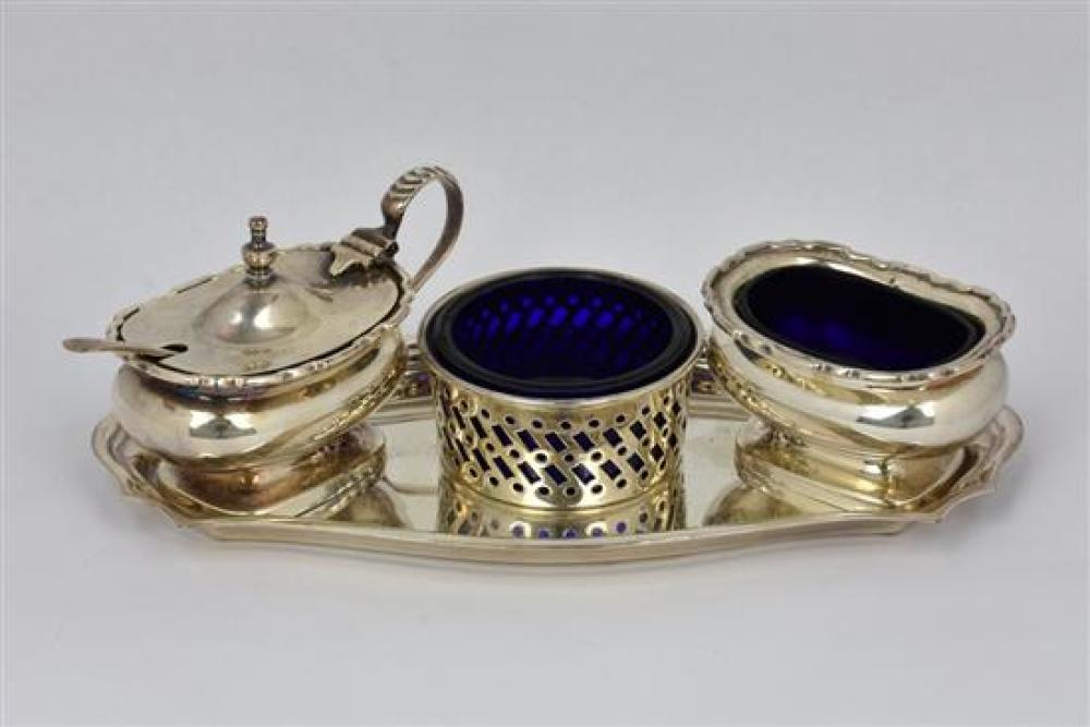 A trio of silver plate condiments and tray a good match, each having cobalt blue liners. * Condition: One liner with chip.