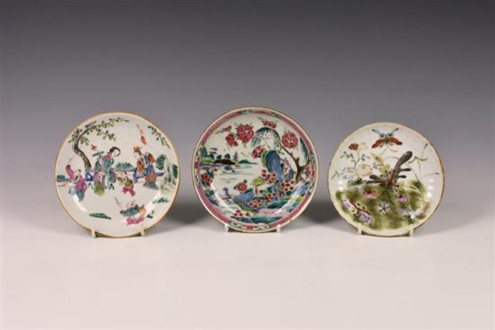 Three Chinese porcelain famille rose dishes the first decorated in polychrome enamels depicting a lake scene with pagoda in the dist...