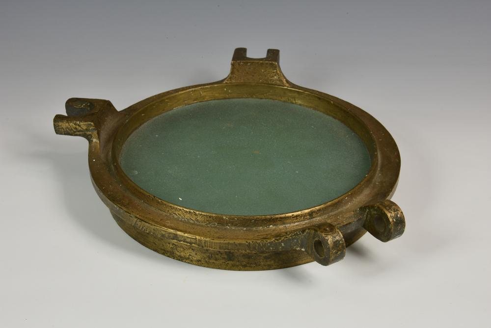 Maritime interest - A cast polished brass nautical ships window / porthole cover of typical form with hinge and window brackets,