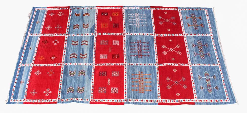 A Moroccan kilim rug late 20th century, with bands of red and light blue divided by red, white and blue guards,