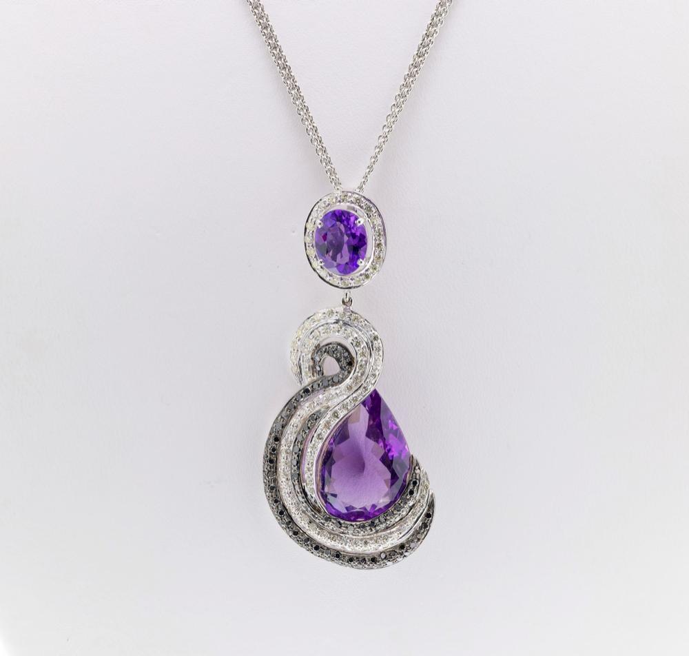 An 18ct white gold, amethyst and diamond necklace and earring suite