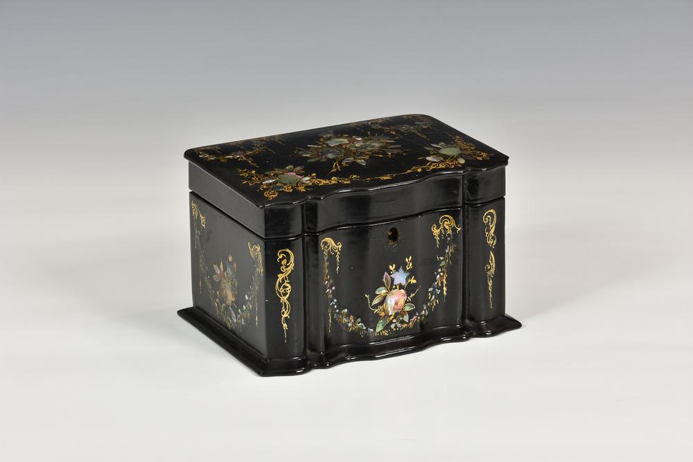 A Victorian papier-mache tea caddy c.1860, of rectangular form with serpentine front, inlaid with mother of pearl,